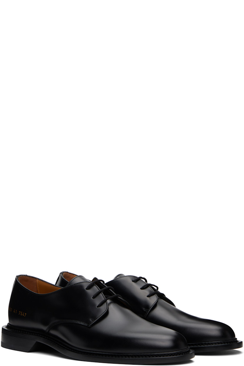 Polished leather derbys in black.

· Almond toe
· Lace-up closure
· Signature series stamp at outer side
· Buffed leather and suede lining
· Topstitching at welt
· Stacked leather heel with rubber injection
· Leather sole

Supplier color: Black