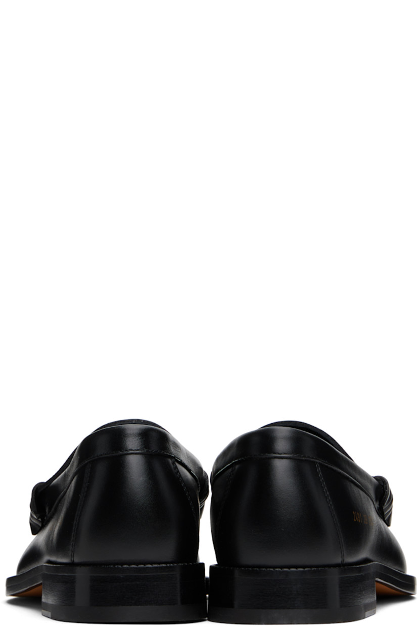 Grained leather loafers in black. 

· Moc toe
· Strap with cutout at vamp
· Signature series stamp at outer side
· Buffed leather lining
· Stacked leather block heel with rubber injection
· Leather sole

Supplier color: Black
