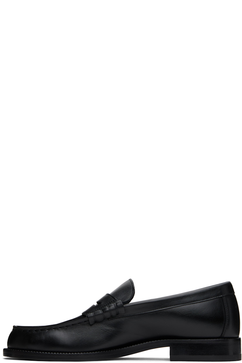 Grained leather loafers in black. 

· Moc toe
· Strap with cutout at vamp
· Signature series stamp at outer side
· Buffed leather lining
· Stacked leather block heel with rubber injection
· Leather sole

Supplier color: Black