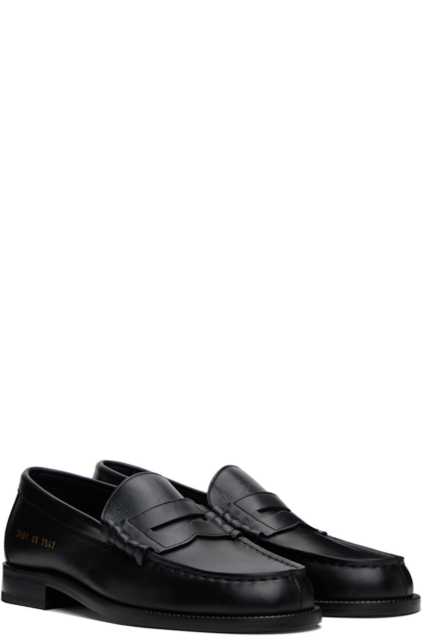 Grained leather loafers in black. 

· Moc toe
· Strap with cutout at vamp
· Signature series stamp at outer side
· Buffed leather lining
· Stacked leather block heel with rubber injection
· Leather sole

Supplier color: Black