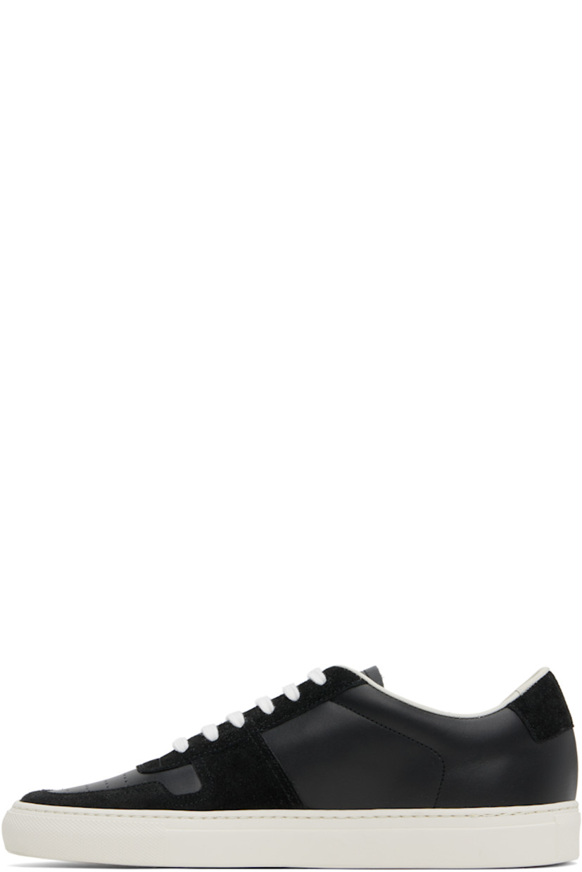 Low-top suede and buffed leather sneakers in black.

· Perforations at toe and outer side
· Lace-up closure
· Padded tongue and collar
· Signature series stamp at outer side
· Buffed leather and suede lining
· Treaded rubber sole

Supplier color: Black