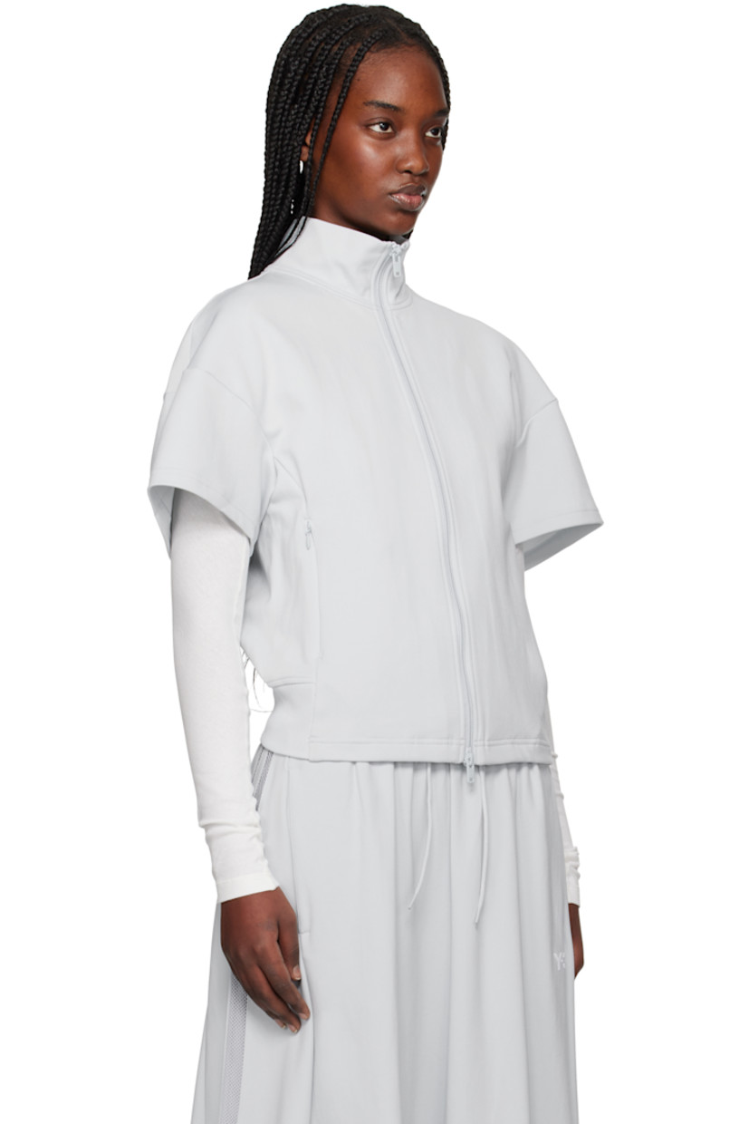 Nylon jersey track jacket. 

· Stand collar
· Two-way zip closure
· Zip pockets
· Partially rib-knit hem 
· Mesh stripes at side seam
· Logo bonded at back collar

Supplier color: Clear grey