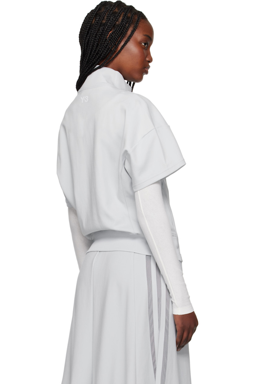 Nylon jersey track jacket. 

· Stand collar
· Two-way zip closure
· Zip pockets
· Partially rib-knit hem 
· Mesh stripes at side seam
· Logo bonded at back collar

Supplier color: Clear grey
