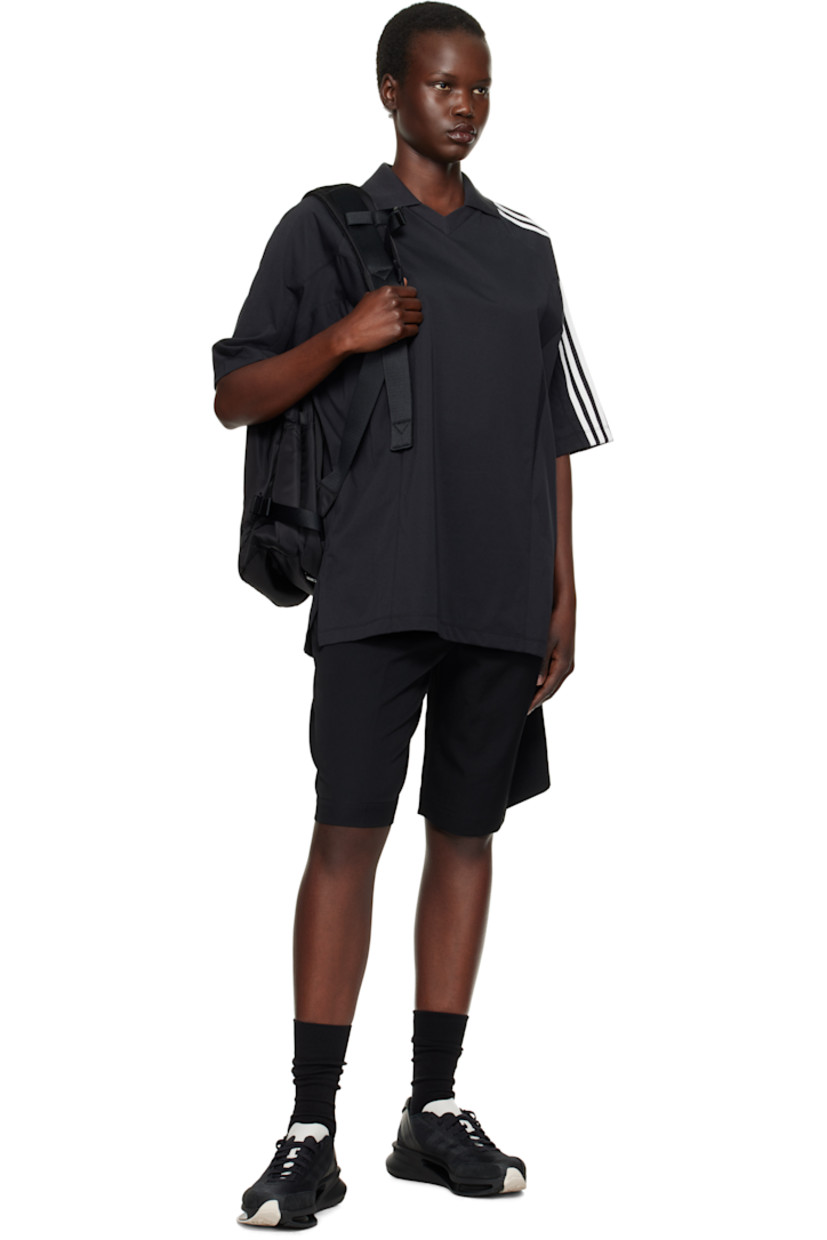 Cotton- and recycled-polyester blend jersey polo. 

· Paneled construction
· Spread collar at rib-knit V-neck
· Raglan sleeves
· Stripes and logo flag at sleeve

Supplier color: Black