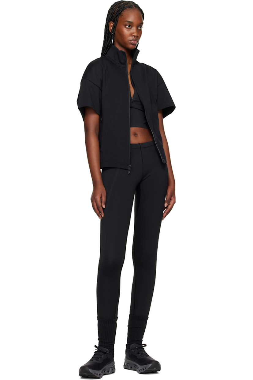 Stretch nylon jersey sport top. 

· Scoop neck
· Half-zip closure
· Logo bonded at front and back
· Cutout at modified racer back

Supplier color: Black