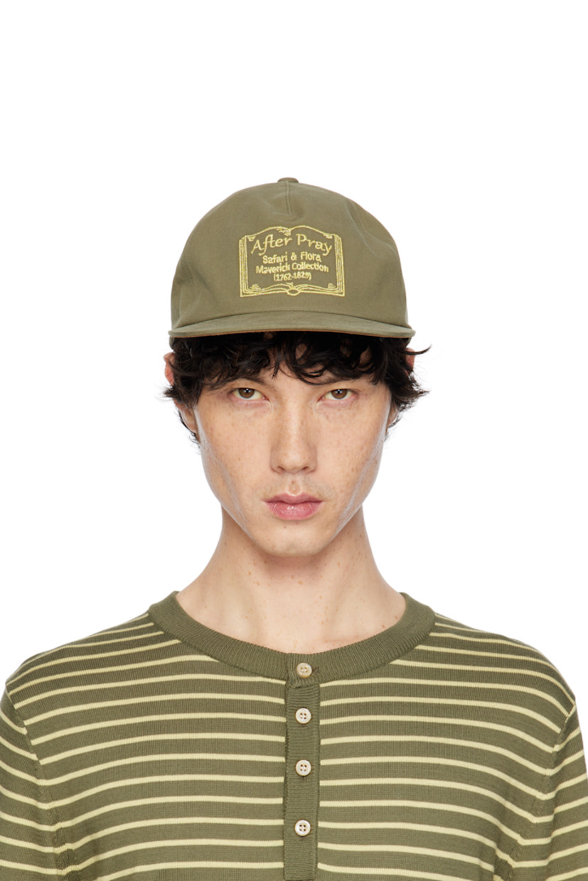 Cotton twill cap in khaki. 

· Embroidered eyelets at crown
· Logo graphic embroidered at face and back face
· Flat brim
· Cinch fastening
· Cotton twill browband
· Felt lining at inner brim

Supplier color: Khaki