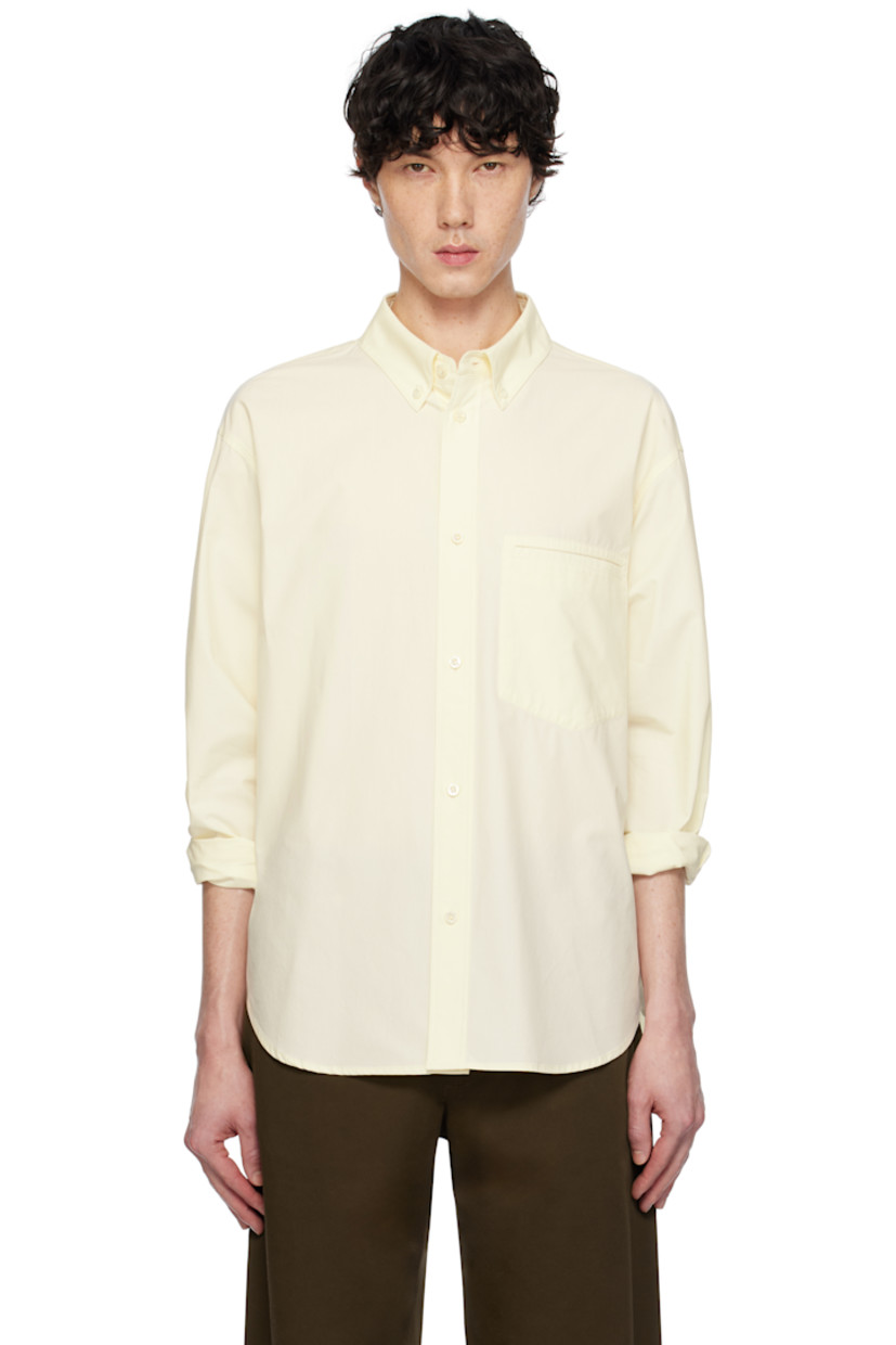 Cotton poplin shirt. 

· Spread collar
· Button closure
· Patch pocket at chest
· Shirttail hem
· Dropped shoulders
· Single-button barrel cuffs
· Box pleat and locker loop at back yoke

Supplier color: Lemon