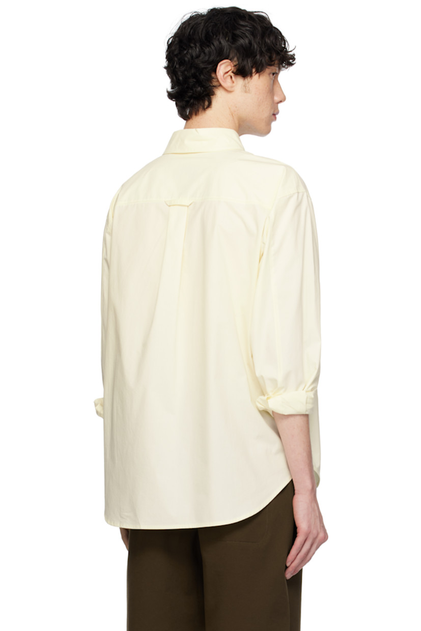 Cotton poplin shirt. 

· Spread collar
· Button closure
· Patch pocket at chest
· Shirttail hem
· Dropped shoulders
· Single-button barrel cuffs
· Box pleat and locker loop at back yoke

Supplier color: Lemon