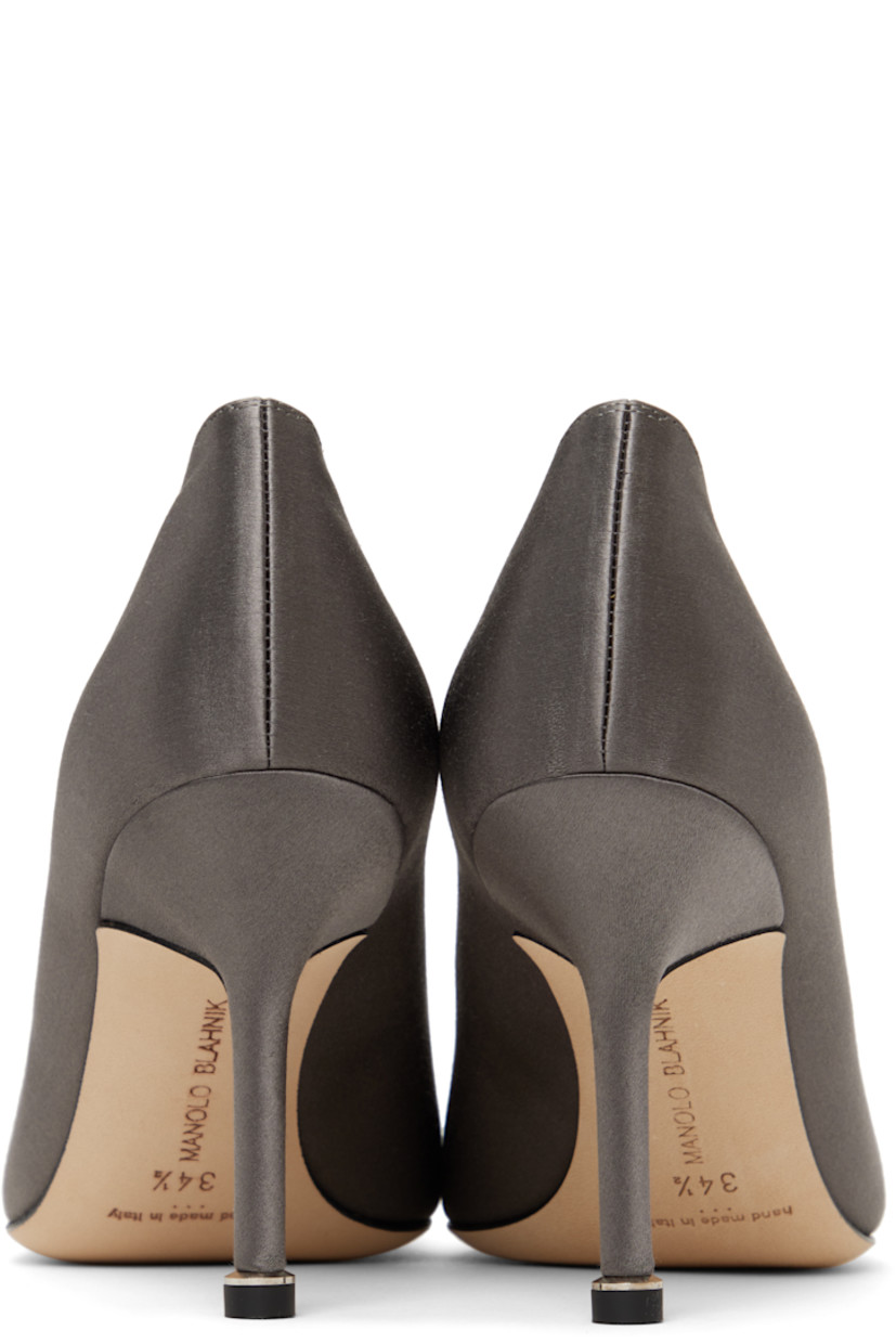 Satin heels in gray. 

· Pointed toe
· Buckle with prong-set crystals at vamp
· Inset logo patch at padded footbed
· Polished goatskin lining
· Covered stiletto heel with rubber injection
· Nubuck sole
· Heel: H3.5"

Supplier color: Dark grey