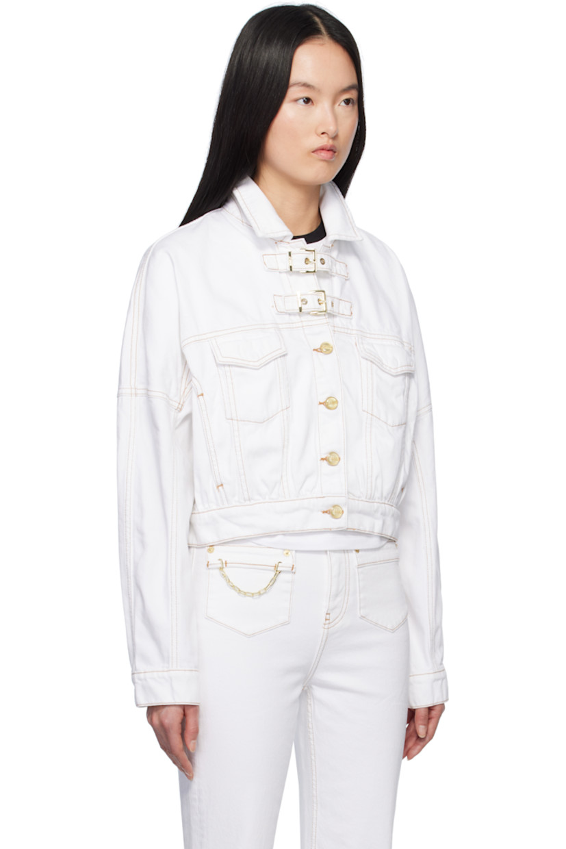 Non-stretch organic cotton denim jacket.

· Spread collar
· Pin-buckle tabs at button closure
· Flap pockets
· Single-button barrel cuffs
· Logo patch at back hem
· Adjustable button tabs at back hem
· Contrast stitching in tan

Supplier color: Bright white