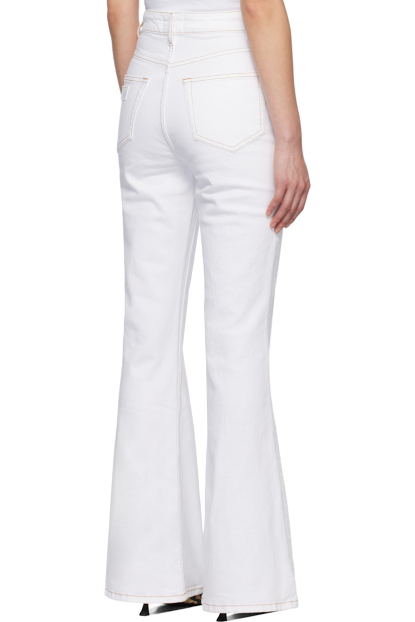 Stretch organic cotton denim jeans.

· Belt loops
· Four-pocket styling
· Zip-fly
· Cable chain at front pocket
· Logo patch at back pocket
· Contrast stitching in tan

Supplier color: Bright white