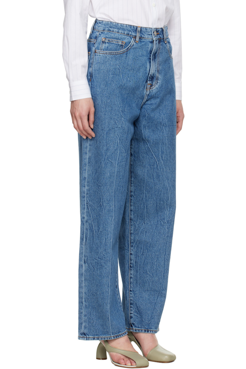 Loose-fit and wide-leg non-stretch denim jeans. Fading and whiskering throughout. 

· Low-rise
· Belt loops
· Five-pocket styling
· Zip fly
· Logo-engraved silver-tone hardware
· Contrast stitching in tan

Supplier color: Mid denim blue