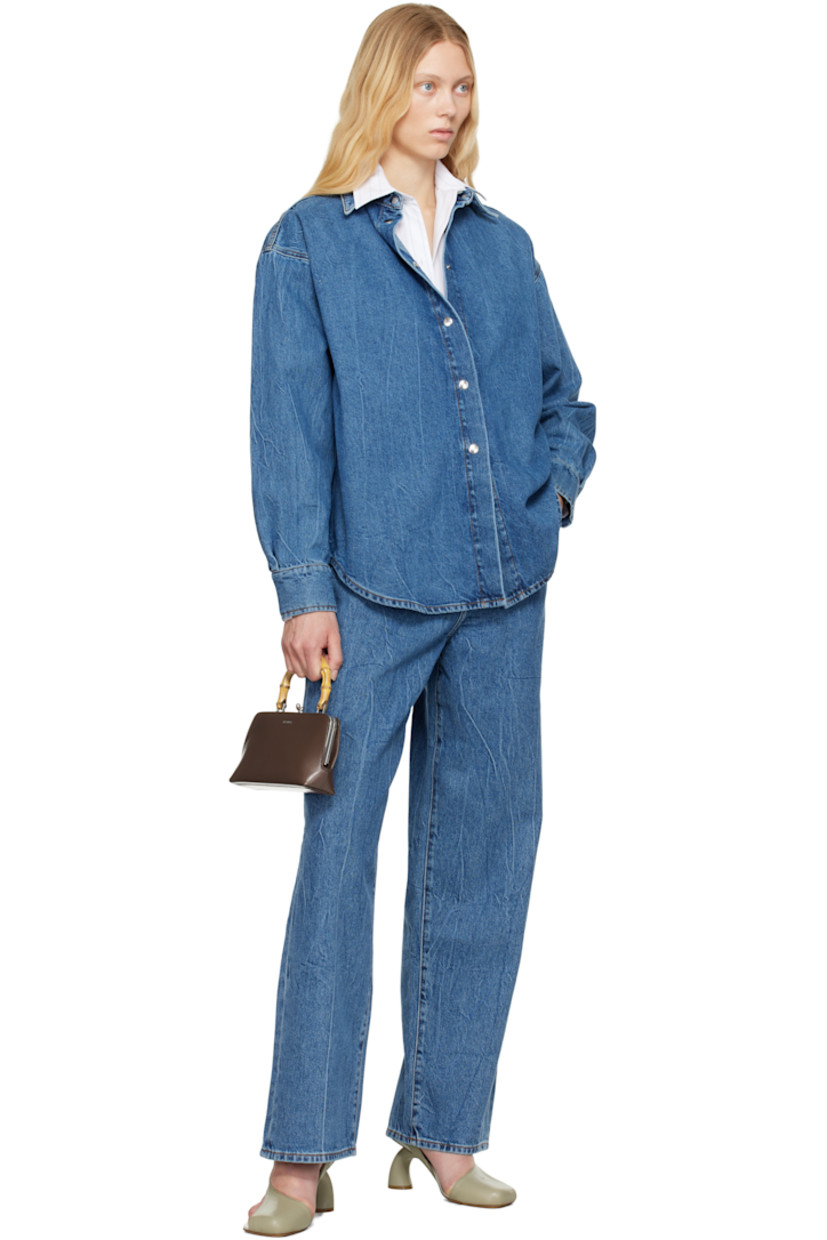 Loose-fit and wide-leg non-stretch denim jeans. Fading and whiskering throughout. 

· Low-rise
· Belt loops
· Five-pocket styling
· Zip fly
· Logo-engraved silver-tone hardware
· Contrast stitching in tan

Supplier color: Mid denim blue
