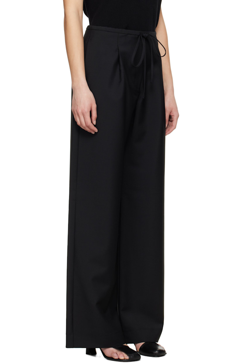 Loose-fit and wide-leg virgin wool- and mohair-blend hopsack trousers.

· Drawstring at waistband
· Four-pocket styling
· Zip fly
· Pleats at front

Supplier color: Black