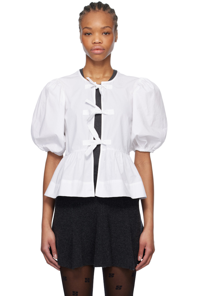 Organic cotton poplin blouse. Gathering throughout. 

· Crewneck
· Self-tie fastenings at open front
· Darts at chest
· Peplum hem
· Puff sleeves
· Elasticized cuffs

Supplier color: Bright white