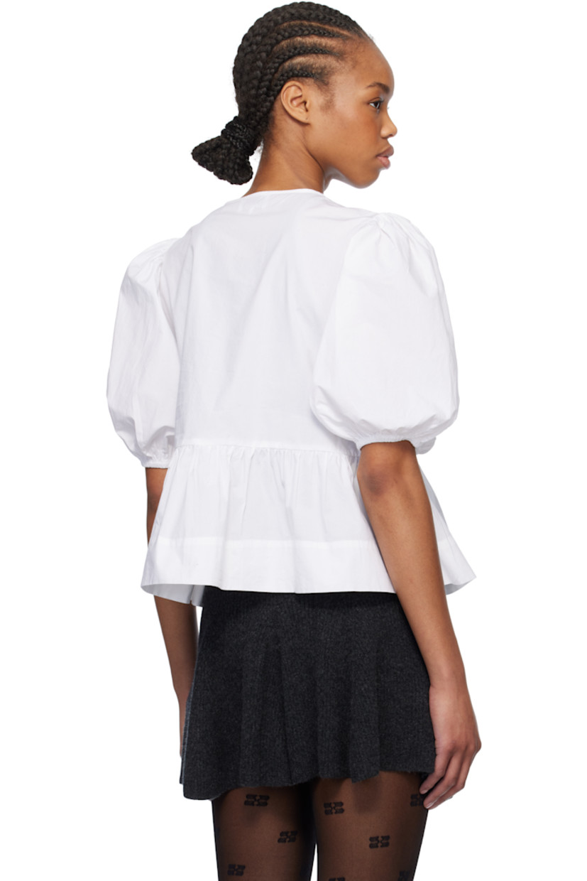 Organic cotton poplin blouse. Gathering throughout. 

· Crewneck
· Self-tie fastenings at open front
· Darts at chest
· Peplum hem
· Puff sleeves
· Elasticized cuffs

Supplier color: Bright white