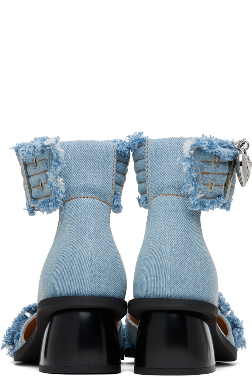 Recycled cotton denim heels in blue. 

· Frayed edges throughout
· Pointed toe
· Pin-buckle strap at vamp
· Pin-buckle ankle strap
· Buffed faux-leather lining
· Covered block heel with rubber injection
· Rubber sole
· Contrast stitching in tan
· Heel: H1.75"

Supplier color: Faded denim