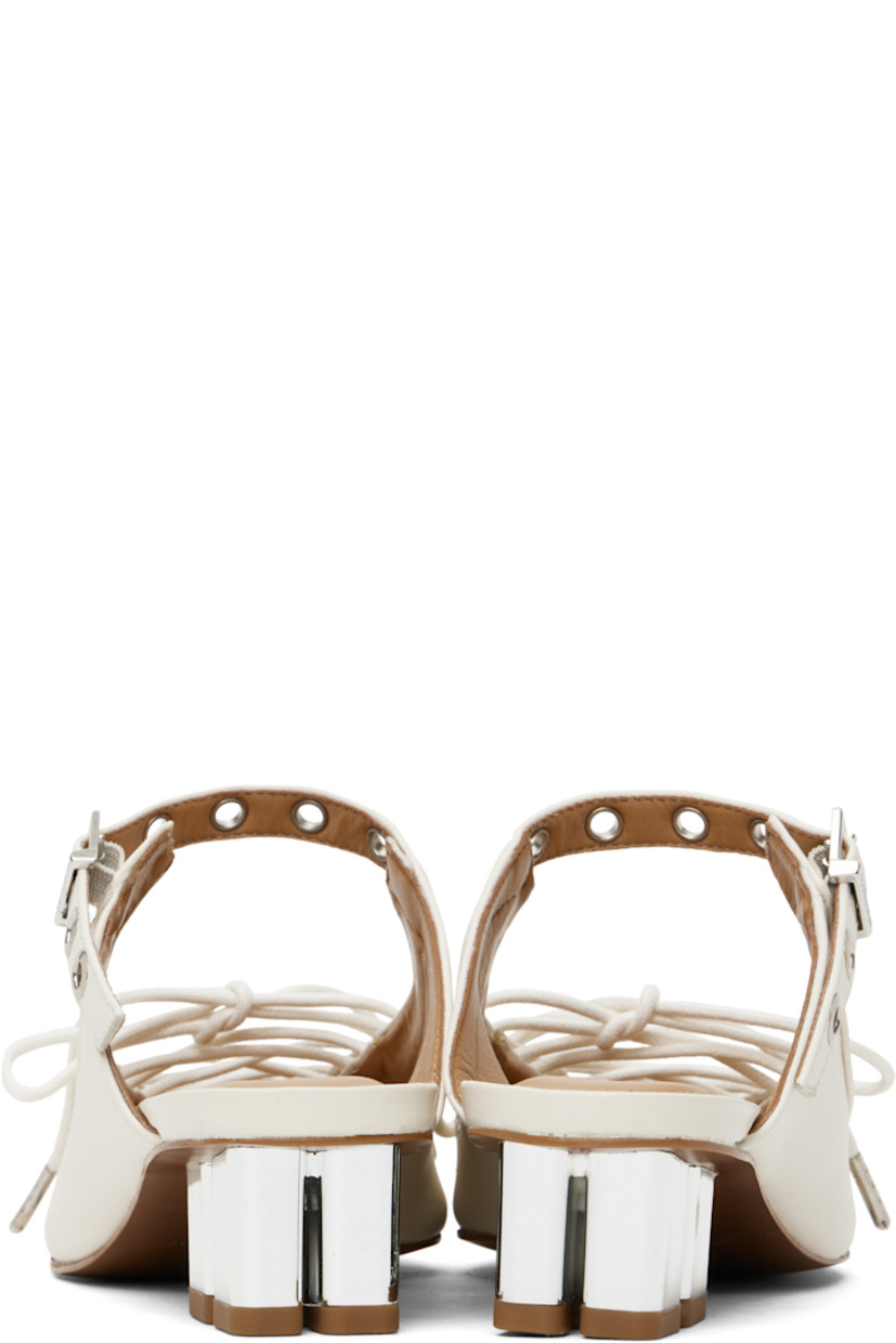 Grained Pélinova® faux-leather mules in off-white. 

· Pointed toe
· Lace-up closure 
· Pin-buckle strap at vamp
· Logo embossed at padded faux-leather footbed
· Logo graphic heel with rubber injection 
· Faux-leather sole with rubber injection
· Logo-engraved silver-tone hardware
· Heel: H1.5"

Supplier color: Egret