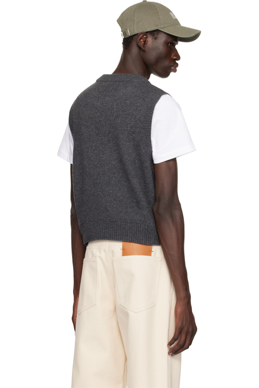 Knit wool- and recycled wool-blend vest.

· Rib-knit crewneck, hem, and armscyes
· Jacquard logo and graphic at front
· Metallic thread detailing at front

Supplier color: Gray quill