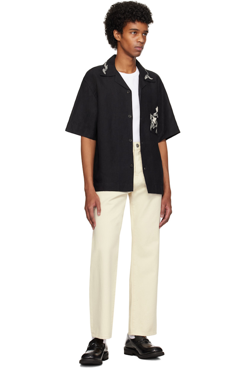 Linen hopsack shirt. Hand-embroidered detailing at collar and pocket.

· Open spread collar
· Button closure
· Patch pocket
· Dropped shoulders

Supplier color: Black
