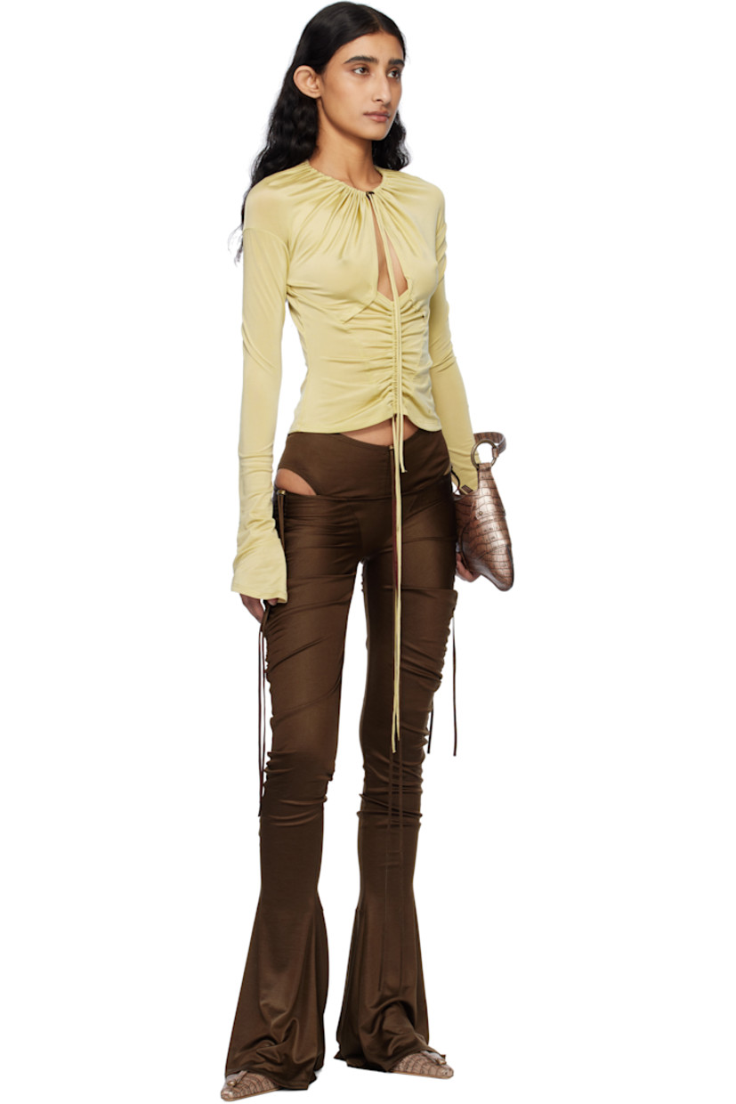 Stretch lyocell jersey blouse. Gathering throughout.

· Bungee-style drawstring at round neck
· Cutout at chest
· Bungee-style drawstring at elasticized central seam 
· Flared cuffs

Supplier color: Pale olive