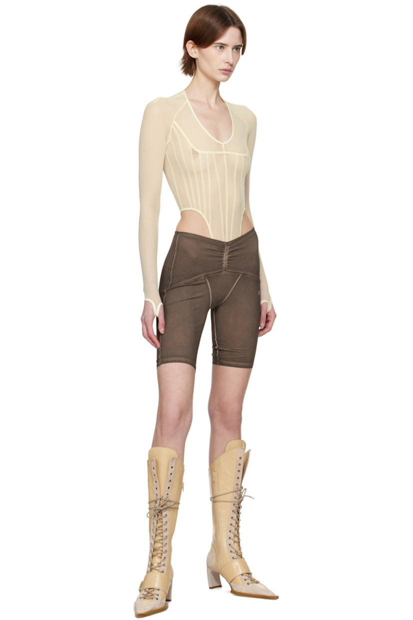 Stretch nylon mesh bodysuit.

· Plunging scoop neck
· Adjustable press-stud closure at bottom
· Thumbhole at cuffs

Supplier color: Ecru