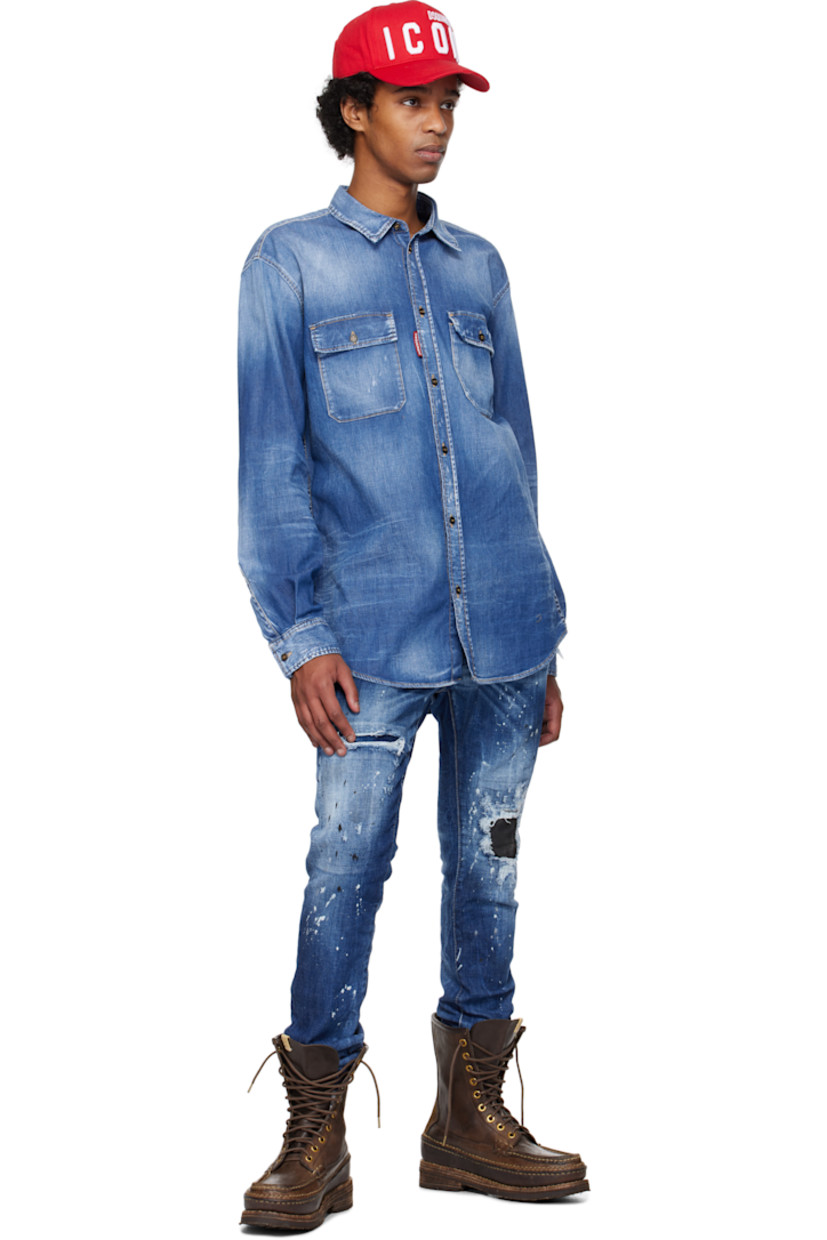 Stretch denim jeans. Fading, distressing, whiskering, and paint splatter throughout. 

· Belt loops
· Five-pocket styling
· Logo flag at button-fly
· Calfskin patch at knee
· Raw edge at cuffs
· Calfskin logo patch at back waistband
· Logo-engraved silver- and copper-tone hardware
· Contrast stitching in tan

Supplier color: Navy