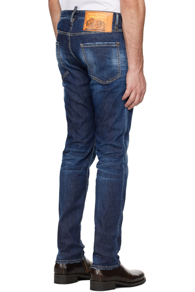 Slim-fit stretch denim jeans. Fading, whiskering, and distressing throughout.

· Belt loops
· Five-pocket styling
· Logo flag at button-fly
· Logo graphic patch at back waistband
· Logo-engraved silver- and copper-tone hardware
· Contrast stitching in tan

Supplier color: Navy blue