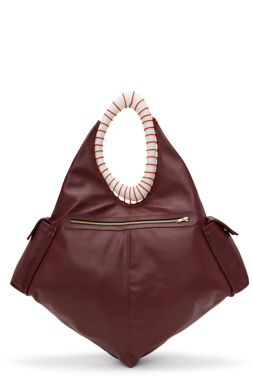 Grained leather tote in burgundy.

· 3D-printed PLA shoulder strap
· Flap pocket at sides
· Zip closure
· Brushed twill lining
· Flannel lining
· H18" x W23" x D6"
· Total height: H29"

Supplier color: Burgundy