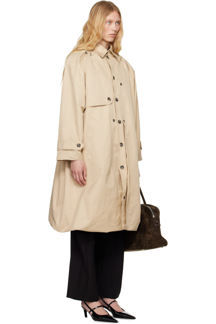Polyester- and cotton-blend twill trench coat. 

· Bungee-style drawstring at round neck
· Button closure
· Storm flap at chest and back
· Welt pockets
· Bubble hem 
· Raglan sleeves 
· Logo patch at cuff
· Button tab at cuffs
· Unlined 

Detachable viscose- and polyester-blend twill vest. 

· Hook-eye fastening at spread collar 
· Button closure
· Welt pocket at interior 
· Full satin lining 

Supplier color: Champagne beige
