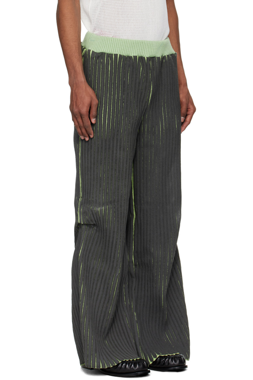Coated rib-knit merino wool- and acrylic-blend trousers. 

· Elasticized waistband
· Three-pocket styling
· Tuck at knees

Supplier color: Black/Green