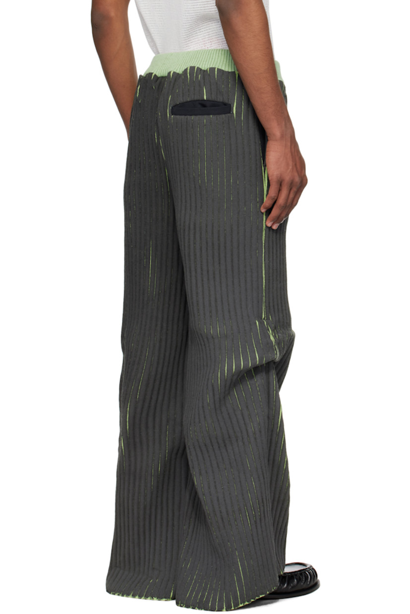 Coated rib-knit merino wool- and acrylic-blend trousers. 

· Elasticized waistband
· Three-pocket styling
· Tuck at knees

Supplier color: Black/Green