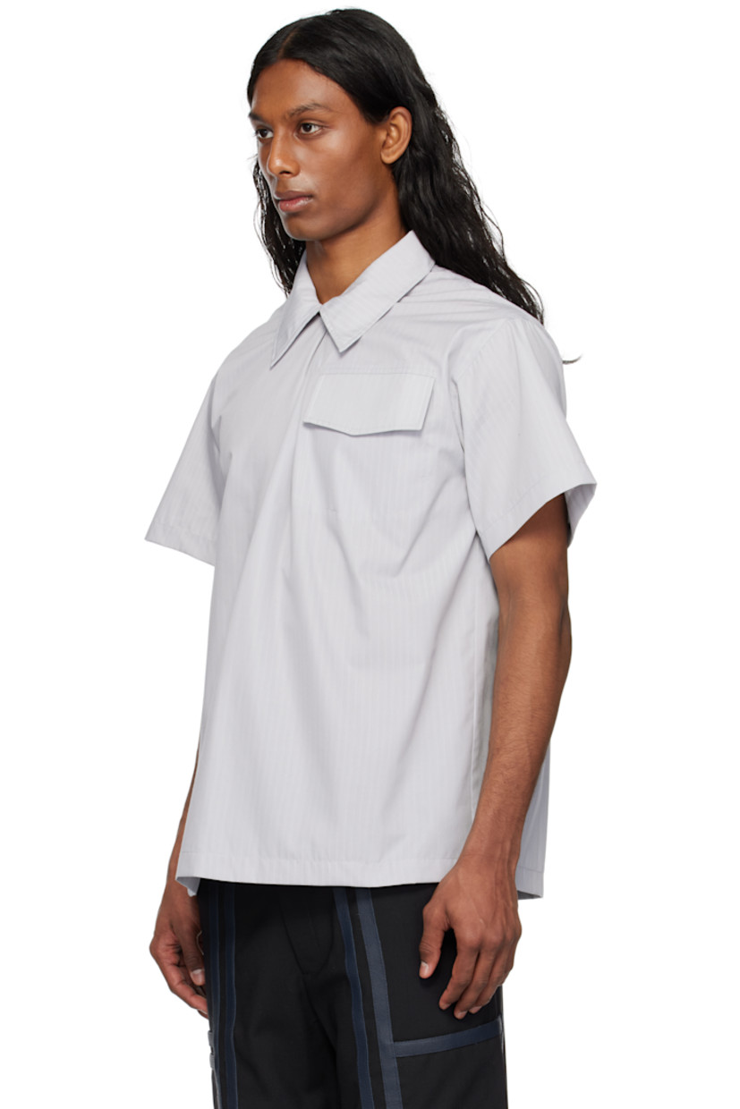 Cotton poplin shirt. Stripes throughout. 

· Press-stud fastening and piping at spread collar
· Flap pocket at chest
· Twin pleats at yoke

Supplier color: Grey