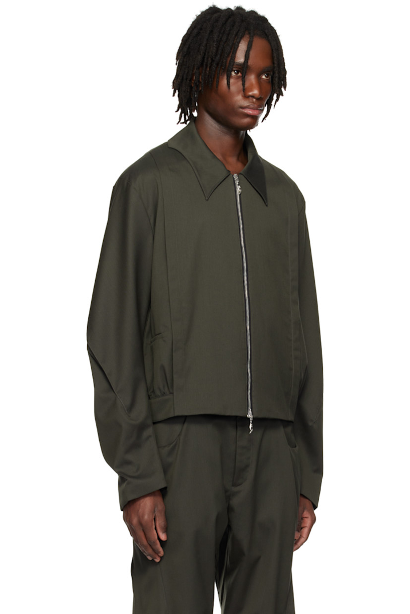 Water-repellent wool- and polyester-blend twill jacket. 

· Modified spread collar
· Two-way zip closure 
· Pintucks at front 
· Welt pockets
· Pleat at sleeves
· Gathering at yoke and back hem 
· Welt pocket at interior 
· Full cupro satin lining 

Supplier color: Tarmac