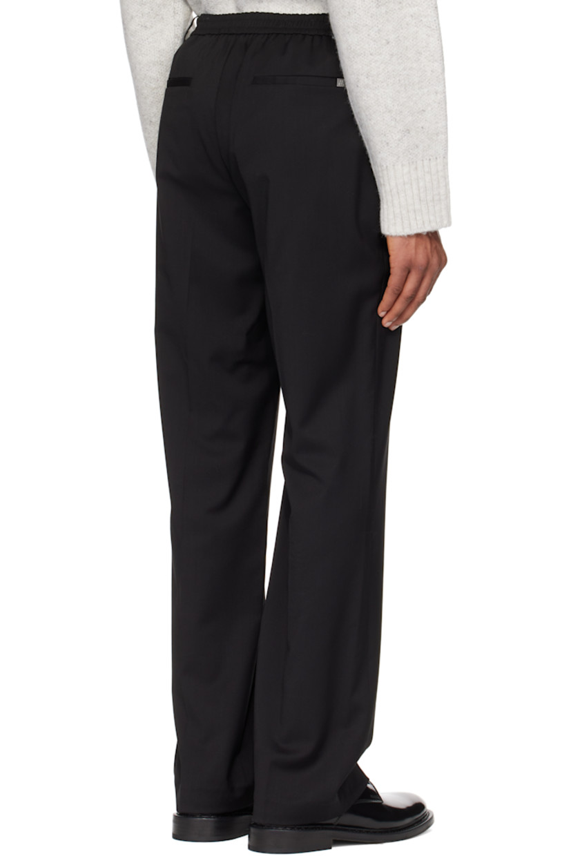 Virgin wool twill trousers. 

· Mid-rise
· Belt loops
· Partially elasticized waistband
· Four-pocket styling
· Zip-fly
· Pinched seams at legs
· Logo plaque at back pocket
· Creases at back
· Partially lined

Supplier color: Black