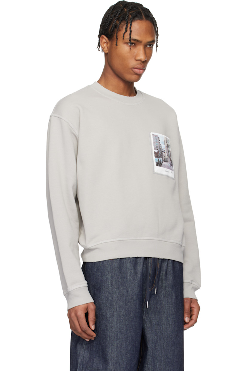 Enzyme-washed French terry sweatshirt. Overlock stitching throughout. 

· Distressing at rib-knit crewneck, hem, and cuffs
· Graphic printed at padded patch pocket
· Dropped shoulders
· Logo and text printed at back 

Featuring artwork by Peter Do.

Supplier color: Heather grey