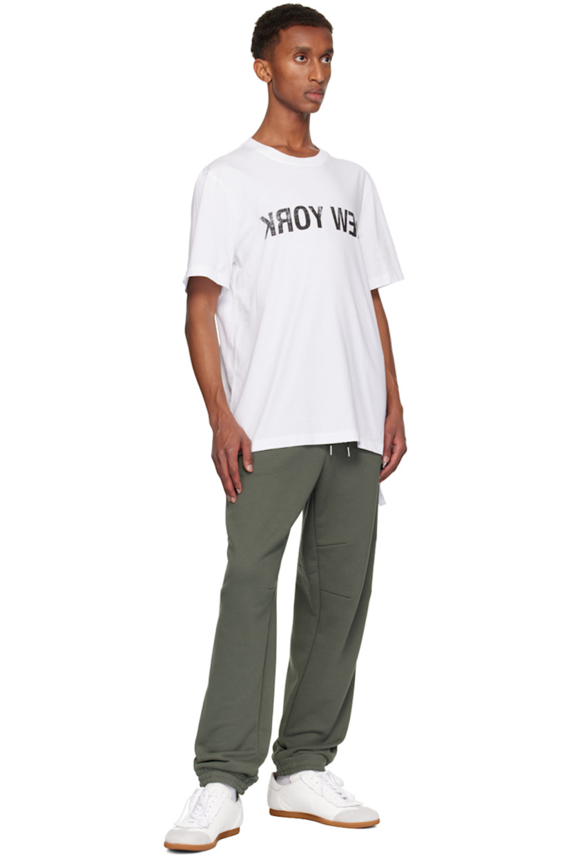 Lightweight cotton jersey T-shirt. Subtle distressing throughout. 

· Relaxed-fit
· Rib-knit crewneck
· Text printed at front
· Cinch strap at hem
· Logo and text printed at back

Supplier color: White