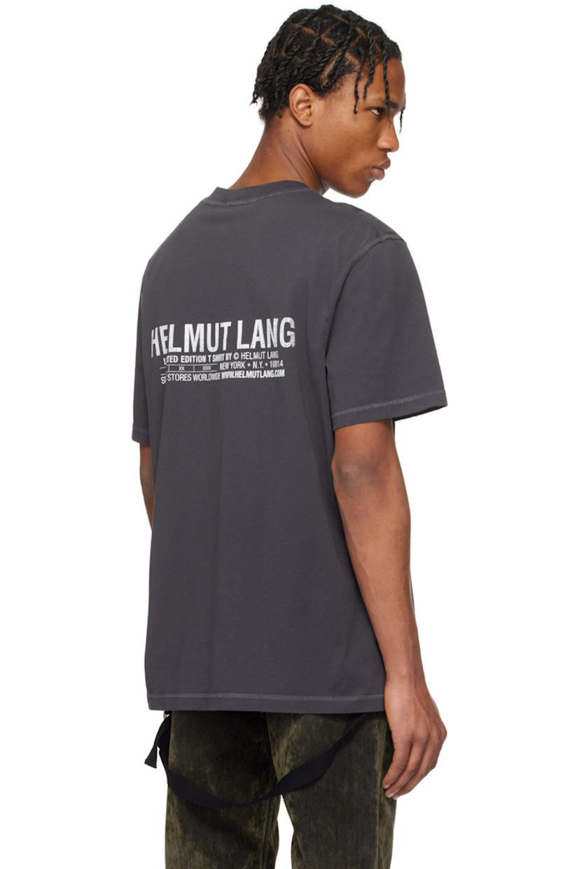 Cotton jersey T-shirt. Overlock stitching throughout. 

· Rib-knit crewneck 
· Distressing at collar, hem, and cuffs
· Text printed at chest
· Adjustable webbing cinch strap at hem
· Text and logo printed at back 

Supplier color: Ash