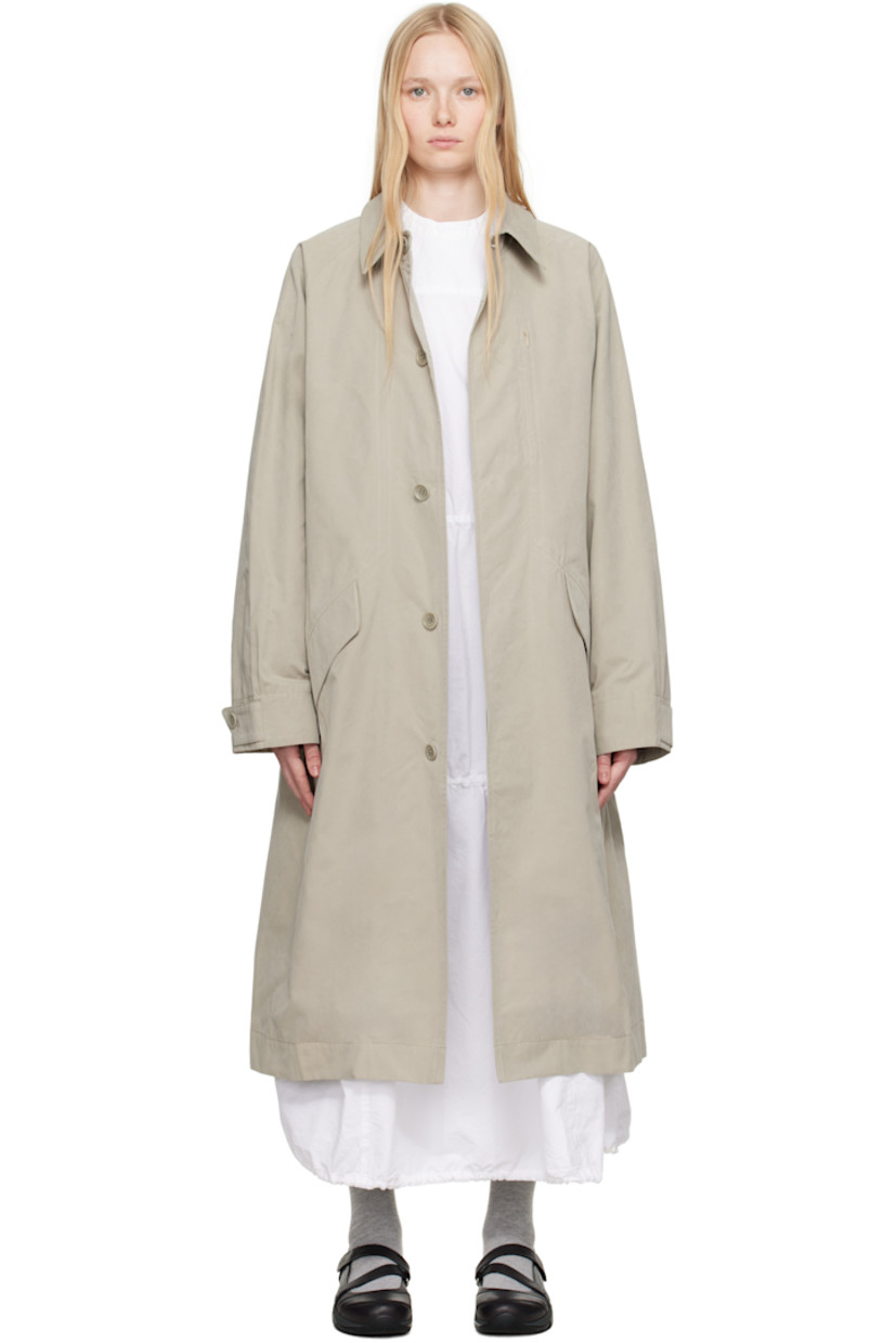 Waxed cotton-blend canvas trench coat. 

· Spread collar
· Concealed button closure
· Zip pocket at chest
· Flap pockets at front 
· Raglan sleeves
· Adjustable button tab at cuffs
· Twin vents at back hem 
· Patch pocket and button tab at interior 
· Full satin lining

Supplier color: Stone