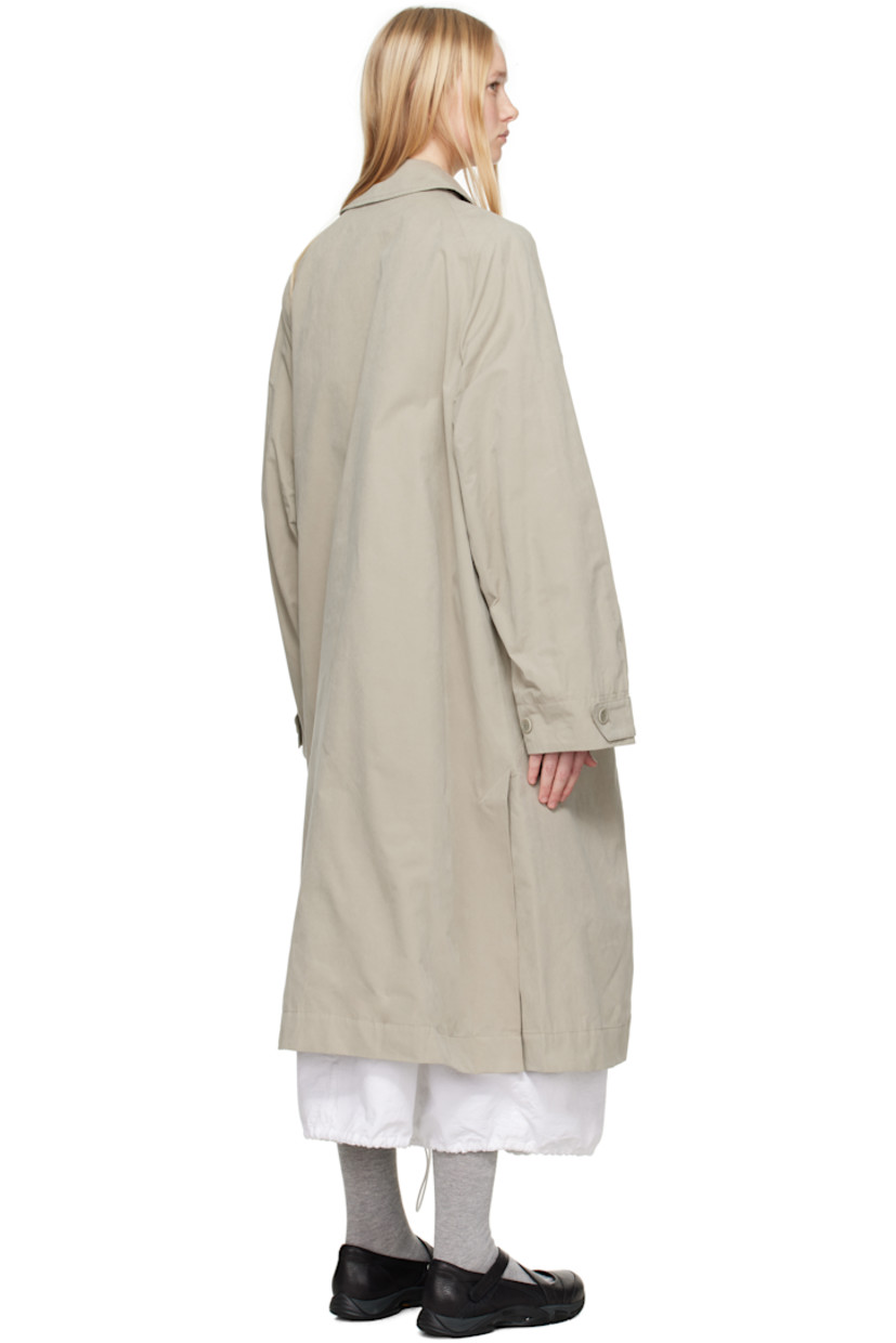 Waxed cotton-blend canvas trench coat. 

· Spread collar
· Concealed button closure
· Zip pocket at chest
· Flap pockets at front 
· Raglan sleeves
· Adjustable button tab at cuffs
· Twin vents at back hem 
· Patch pocket and button tab at interior 
· Full satin lining

Supplier color: Stone