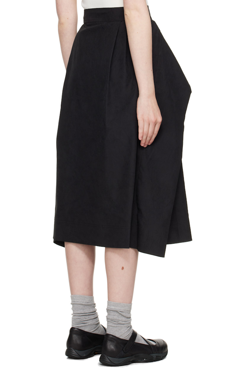 Crinkled polyester taffeta midi skirt. Integrated self-tie panel for alternate styling.

· Wrap construction 
· Four-pocket styling
· Pleats at front 
· Button closure at back
· Corozo hardware

Supplier color: Black