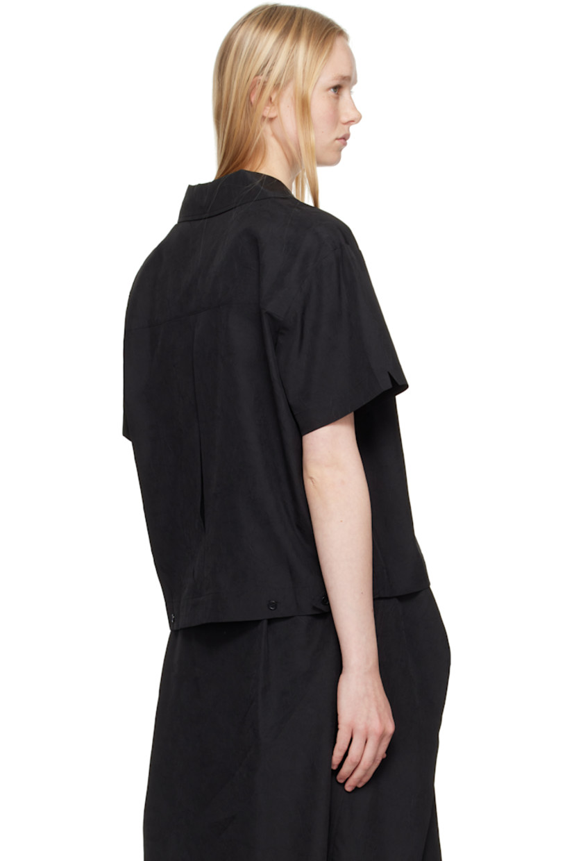 Crinkled polyester taffeta shirt. 

· Open spread collar
· Button closure
· Patch pocket
· Inverted box pleat at back 
· Adjustable button tabs at back hem 
· Corozo hardware 

Supplier color: Black