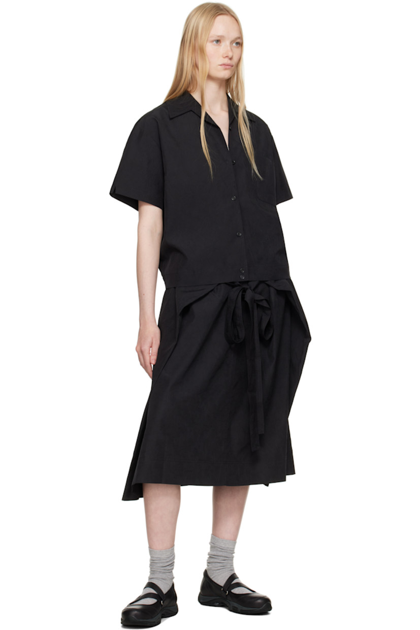 Crinkled polyester taffeta shirt. 

· Open spread collar
· Button closure
· Patch pocket
· Inverted box pleat at back 
· Adjustable button tabs at back hem 
· Corozo hardware 

Supplier color: Black
