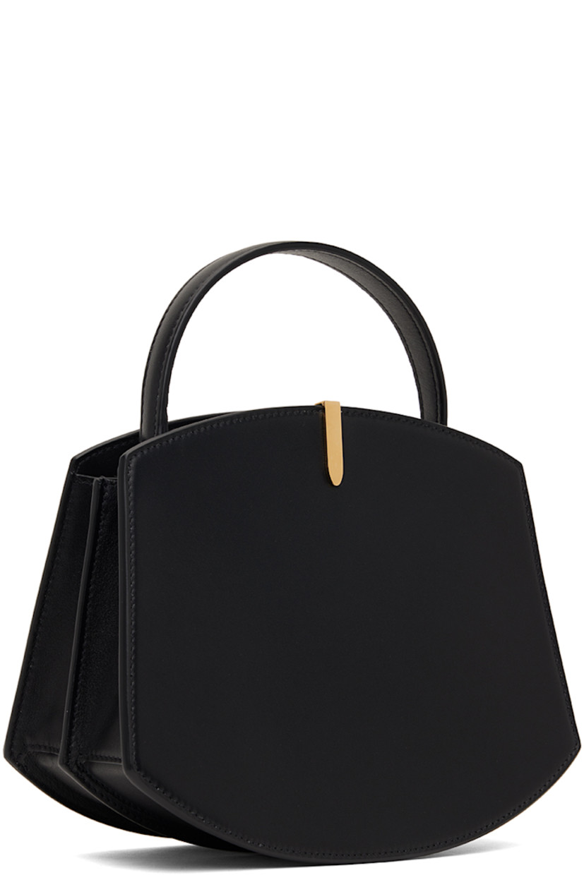 Buffed calfskin top handle bag in black.

· Fixed carry handle
· Gold-tone hardware at face 
· Accordion panel at sides
· Logo stamp at back face 
· Magnetic tab closure 
· Card slot at two-compartment interior
· Buffed calfskin lining 
· H6.75" x W8.25 x D4"
· Total height: H9.5"

Supplier color: Black