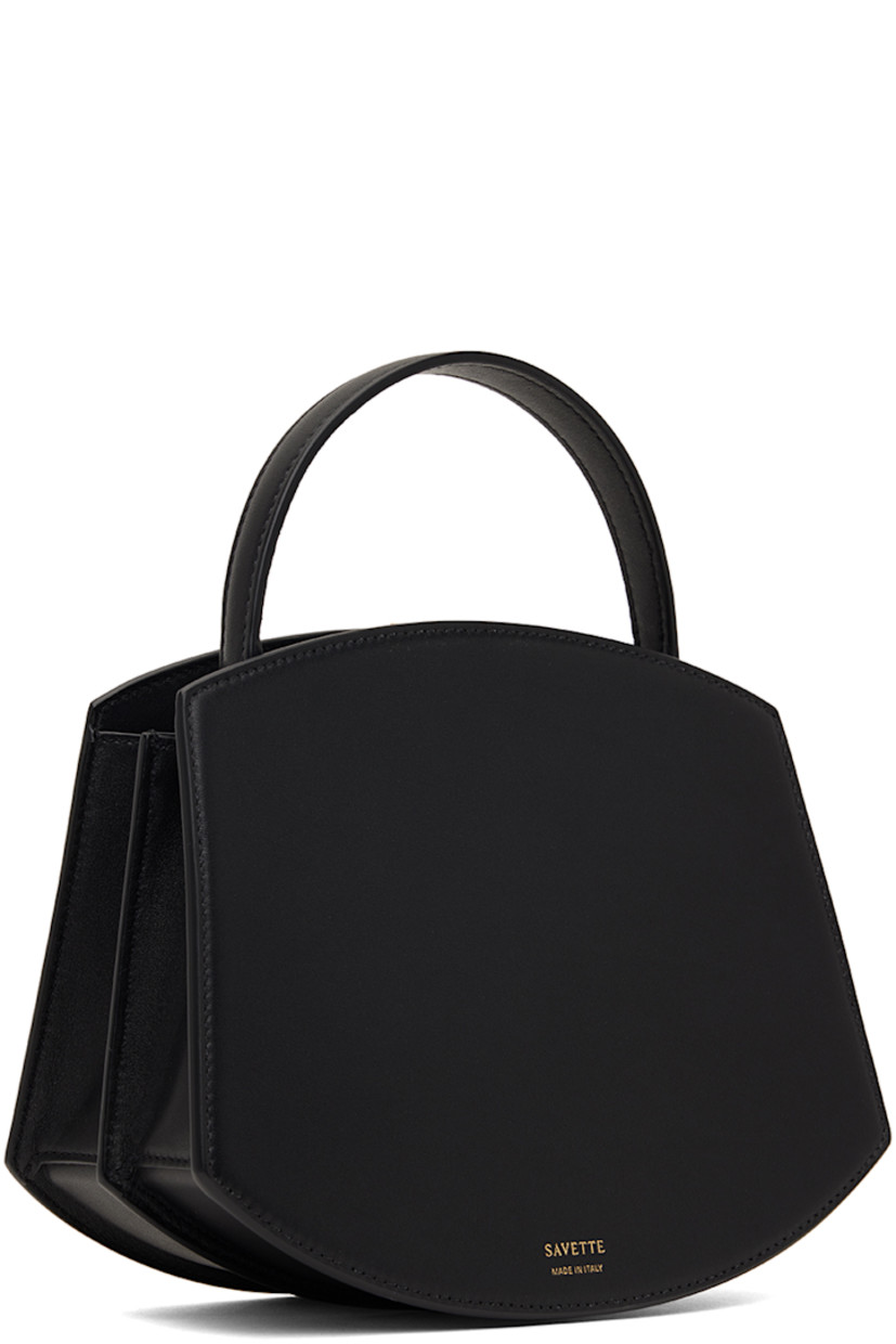 Buffed calfskin top handle bag in black.

· Fixed carry handle
· Gold-tone hardware at face 
· Accordion panel at sides
· Logo stamp at back face 
· Magnetic tab closure 
· Card slot at two-compartment interior
· Buffed calfskin lining 
· H6.75" x W8.25 x D4"
· Total height: H9.5"

Supplier color: Black