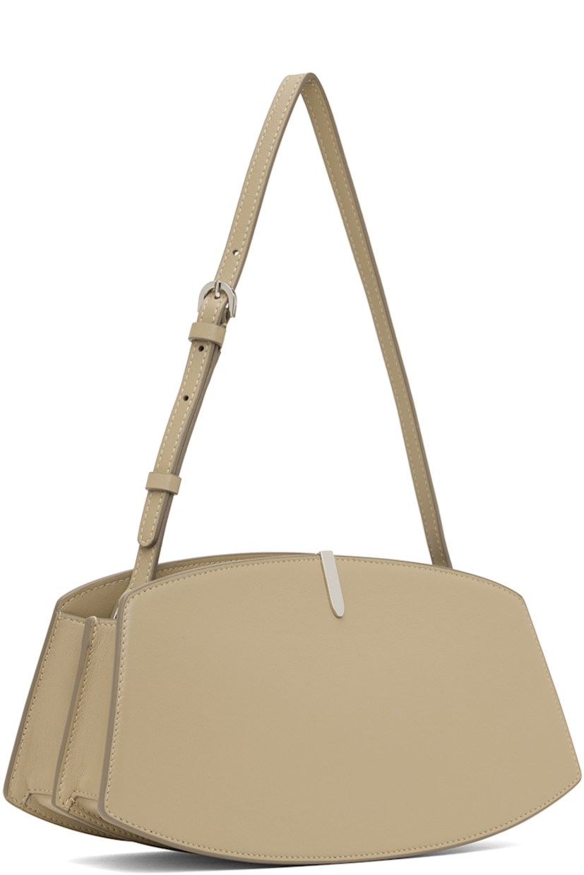 Buffed calfskin shoulder bag in beige.

· Adjustable shoulder strap 
· Silver-tone hardware at face 
· Accordion panel at sides
· Logo stamp at back face 
· Magnetic tab closure 
· Card slot at two-compartment interior
· Buffed calfskin lining 
· H5.75" x W10.75 x D4"

Supplier color: Clay