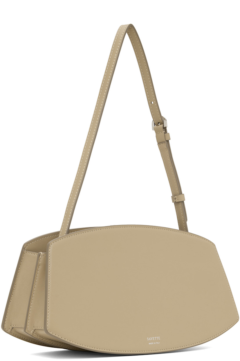 Buffed calfskin shoulder bag in beige.

· Adjustable shoulder strap 
· Silver-tone hardware at face 
· Accordion panel at sides
· Logo stamp at back face 
· Magnetic tab closure 
· Card slot at two-compartment interior
· Buffed calfskin lining 
· H5.75" x W10.75 x D4"

Supplier color: Clay