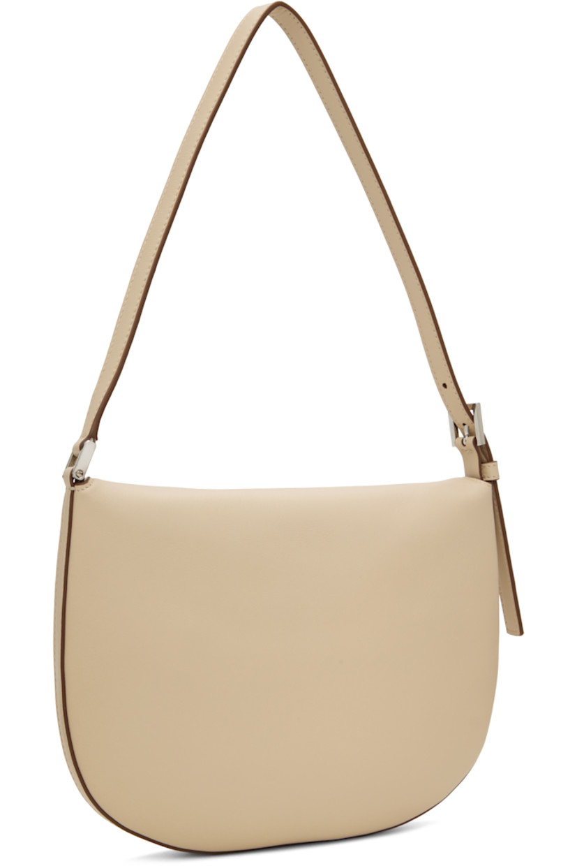 Buffed calfskin shoulder bag in beige.

· Burnished edges throughout
· Adjustable shoulder strap
· Tab-slot flap
· Card slot at interior
· Calfskin suede interior
· H7.5" x W10" x D0.75"

Supplier color: Bone