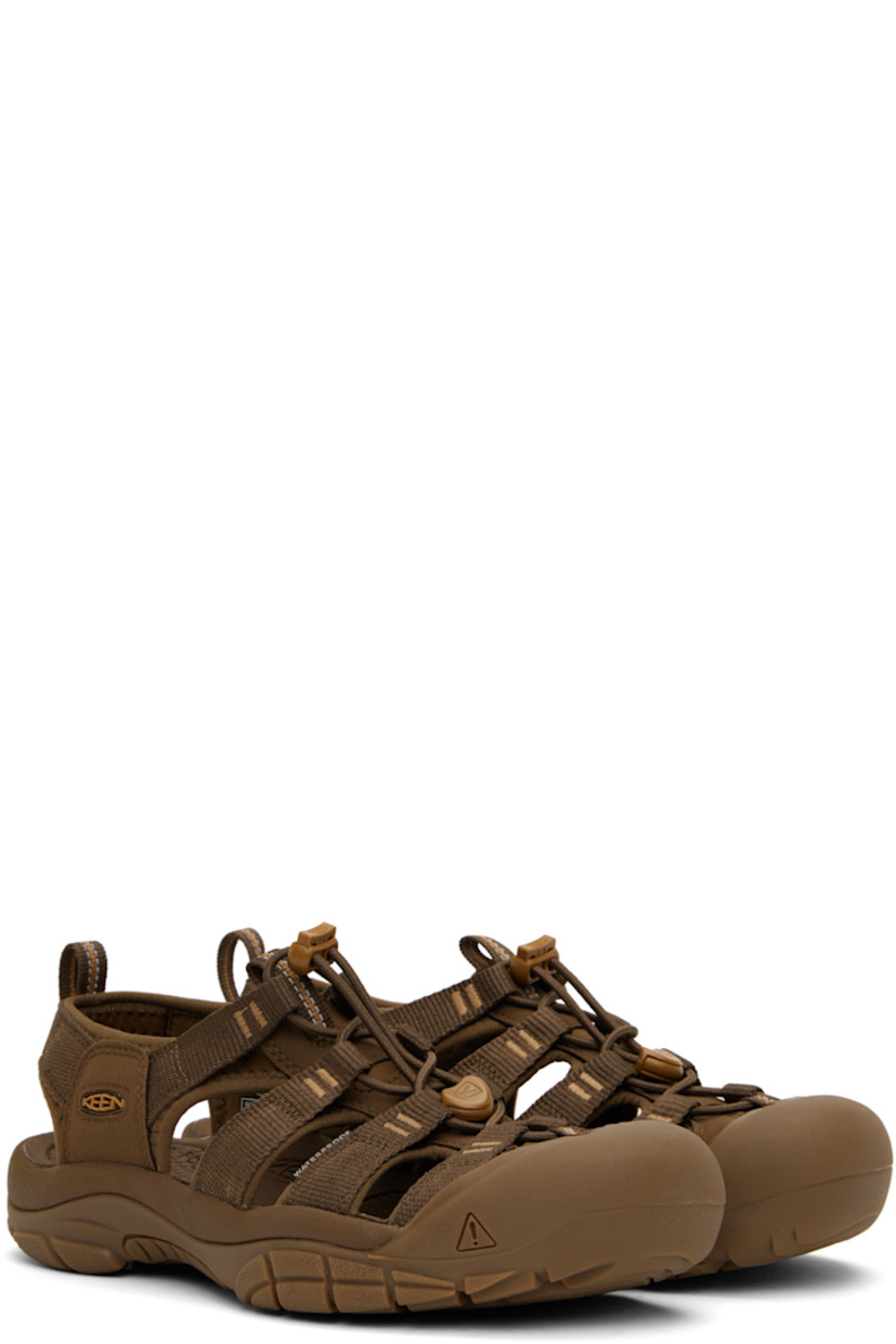 Webbing and faux-suede sandals in brown.

· Anti-odor
· Cutouts throughout
· KEEN.PROTECT rubber cap toe
· Bungee-style lace-up closure
· Pull-loop at heel collar
· Rubberized logo patch at outer side
· Shock-absorbing molded foam insole
· Jersey lining
· Foam rubber midsole
· Treaded rubber sole

Supplier color: Monochrome/Dark earth