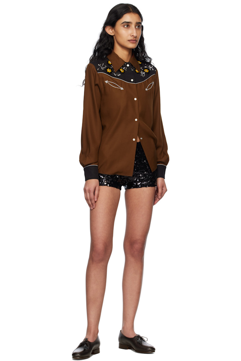 Sequinned polyester mesh shorts.

· Elasticized waistband and cuffs
· Full jersey lining

This item is part of a limited run of 30.

Supplier color: Black